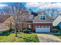 Charming two-story home features a brick facade, dormer, and attached two car garage at 6869 W Winding, McCordsville, IN 46055