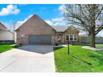 Charming brick home with attached garage and well-maintained front lawn at 701 Downing Dr, Greenwood, IN 46143