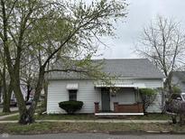 Charming single-story home with mature trees and a cozy front porch at 743 Wilson St, Columbus, IN 47201