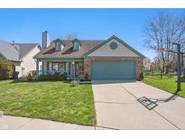 Charming one-story home featuring a two-car garage, inviting front porch, and well-maintained lawn at 10875 Santa Anita Ct, Carmel, IN 46280