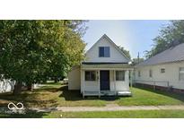 Charming two-story home with a classic architectural style and a well-maintained front yard at 116 N Vine St, Shelbyville, IN 46176