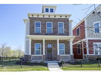 Charming brick two-story home featuring a welcoming front porch and professionally landscaped front yard at 13107 Pennington Rd, Fishers, IN 46037