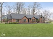 Charming brick home featuring a manicured lawn, stylish landscaping, and a well-maintained exterior at 142 W 88Th St, Indianapolis, IN 46260