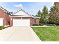 Charming brick home featuring a well-manicured lawn and attached two-car garage at 16311 Sunland Ct, Westfield, IN 46074