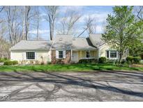 Charming, sunlit home featuring a well-manicured lawn and inviting curb appeal on a tree-lined street at 1920 Mystic Bay Ct, Indianapolis, IN 46240