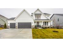 Stunning two-story home boasts modern farmhouse style with a three-car garage and lush landscaping at 19983 Chatham Green Dr, Westfield, IN 46074