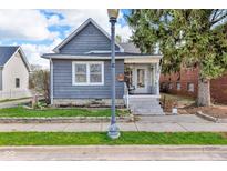 Charming home featuring a well-kept lawn, classic architecture, and inviting front porch at 211 N Merrill St, Fortville, IN 46040