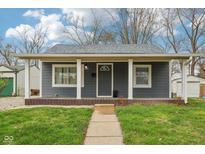 Charming home featuring a covered front porch with white columns and a gray exterior at 2336 St Paul St, Indianapolis, IN 46203