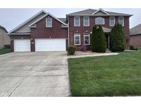 Beautiful brick two-story home with attached two car garage and mature landscaping at 3806 Sycamore Bend S Way, Columbus, IN 47203