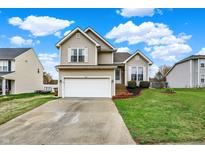 Charming two-story home features a well-maintained lawn and a two-car attached garage at 6064 Brandermill Rdg, Columbus, IN 47203