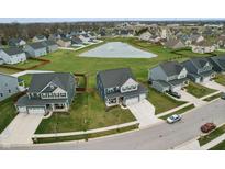 Aerial view of a neighborhood with a pond, showcasing the property's location and community amenities at 7391 Blandford Dr, Plainfield, IN 46168