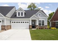 Charming home with a two-car garage and well-manicured lawn at 745 Stone Trace Ct, Avon, IN 46123