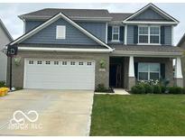 Charming two-story home with a well-manicured lawn and attached two car garage at 9851 Pica Dr, Fishers, IN 46040