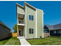 Striking contemporary home boasts a unique three-story design with a private balcony and modern curb appeal at 1038 St Peter St, Indianapolis, IN 46203