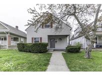 Charming two-story home featuring a covered front porch and well-maintained landscaping, creating curb appeal at 126 S 3Rd Ave, Beech Grove, IN 46107