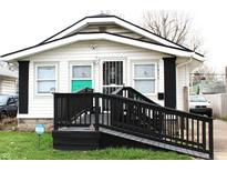 Charming home with black and white painted exterior, convenient access ramp and Ring security at 1311 N Denny St, Indianapolis, IN 46201