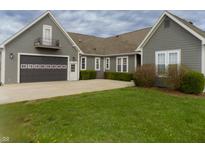 Charming home featuring a spacious driveway, two-car garage, and lush green lawn at 13151 Walters Rd, Martinsville, IN 46151