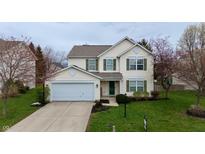 Charming two-story home with a well-maintained lawn and attached two-car garage at 13993 Whittier Dr, Fishers, IN 46038