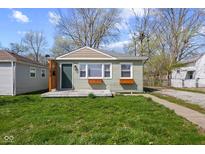 Charming single-story home with light green siding, a well-maintained lawn, and a cozy, inviting curb appeal at 1836 N Riley Ave, Indianapolis, IN 46218