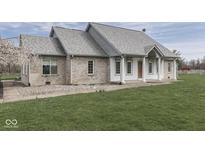 Charming brick and stucco home featuring a well-maintained lawn and welcoming entryway at 1873 S 510 E, Franklin, IN 46131