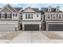 Modern townhome exterior features a paved driveway and attached garage at 18739 Moray St, Westfield, IN 46074