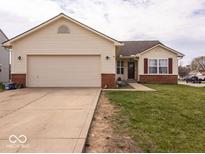 Charming single-Gathering home with a two-car garage, vinyl siding, and a well-maintained front lawn at 2179 W Van Arsdall Ct, Columbus, IN 47201