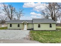 Charming one-story home with light green siding, gray roof, and a gravel front yard at 2264 Walnut W St, Greenfield, IN 46140