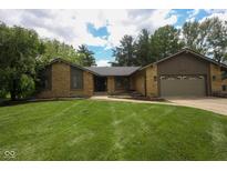 Charming single-story stone home with a well-manicured lawn and attached garage at 3037 Santiago Dr, Greenwood, IN 46143