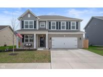 Charming two-story home with a two-car garage, covered front porch, and a swing at 315 Limerick Ln, Pendleton, IN 46064