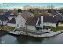 Waterfront home with deck, gazebo, and hot tub overlooking calm water, providing serene outdoor living at 3260 Eddy Ct, Indianapolis, IN 46214