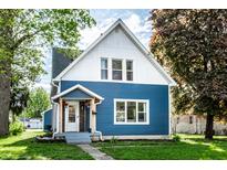 Charming two-story home with a blue exterior, well-maintained lawn, and inviting front porch at 421 S East St, Plainfield, IN 46168