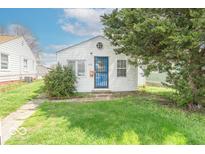 Charming home with a quaint front yard and blue door, under a sunny sky at 555 Leeds Ave, Indianapolis, IN 46203