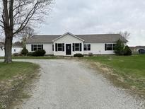 Charming ranch home with a gravel driveway, well-manicured lawn, and classic black shutters at 6431 W 800 S, Pendleton, IN 46064