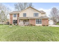 Charming two-story home featuring a well-manicured lawn and a mix of brick and siding exterior at 716 Winter Way, Carmel, IN 46032