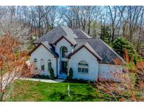 Elegant two-story home with a brick facade, arched windows, and a manicured lawn at 7957 Preservation Dr, Indianapolis, IN 46278