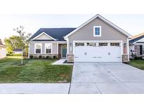 Charming single-Gathering home featuring a two-car garage, stone accents, and well-manicured front lawn at 955 Sand Hollow Dr, Lebanon, IN 46052