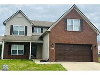 Charming two-story home with brick and vinyl siding, attached garage, and well-maintained lawn at 1071 Hazelwood Dr, Greenwood, IN 46143