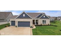 Charming home featuring a two-car garage, a well-manicured lawn, and neutral brick exterior at 11450 Wicker Ln, Noblesville, IN 46060