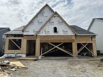 Exterior view of a home under construction, featuring wood framing and Tyvek wrap at 141 Creststone Blvd, Westfield, IN 46074