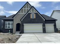 Charming new construction home featuring a stylish mix of stone and brick exterior with an attached two-car garage at 141 Creststone Blvd, Westfield, IN 46074