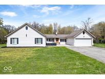 Charming single-story home with a white painted brick facade, attached garage, and well-maintained lawn at 1520 E 87Th St, Indianapolis, IN 46240