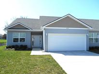 Charming single-story home featuring a two-car garage, manicured lawn, and welcoming front entrance at 1615 Capra Ct, Beech Grove, IN 46107