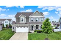 Charming two-story home featuring stone accents, a well-manicured lawn, and an attached two car garage at 16491 Wheatley Ct, Fishers, IN 46040