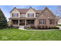 Charming two-story home with manicured lawn, covered porch, brick accents, and classic curb appeal at 20251 Dayspring Ct, Noblesville, IN 46062