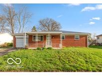 Charming single-story brick home with covered front porch and well-maintained lawn at 5838 W Henry St, Indianapolis, IN 46241