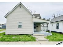Charming home with neutral siding, inviting front porch and well-maintained lawn at 648 W South St, Shelbyville, IN 46176