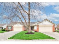 Charming single story home featuring a two-car garage and well-manicured lawn at 7150 Brant Pointe Cir, Indianapolis, IN 46217
