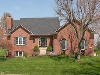 Charming brick home features a well-manicured lawn and inviting front entrance, creating a warm and welcoming curb appeal at 7322 Franklin Parke Ct, Indianapolis, IN 46259