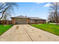 Charming brick home featuring a two-car garage, well-kept lawn, and welcoming curb appeal at 7714 Kenneth Ct, Brownsburg, IN 46112