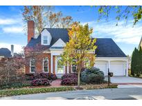 Charming brick home with dormers, two-car garage, and colorful landscaping at 8040 Lynch Ln, Indianapolis, IN 46250